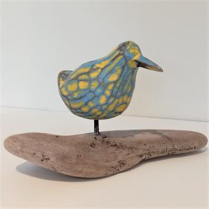 CARVED WOODEN BIRD ON DRIFTWOOD