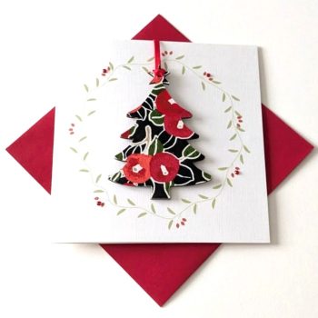 Square handmade greeting card with a red envelope. The card features a printed vine wreath with applied crystals. In the centre, a wooden tree shaped ornament is suspended by a red ribbon. The front of the wooden tree is hand-decoupaged with authentic Japanese Chiyogami paper featuring a red berries and leaf pattern with metallic gold accents.